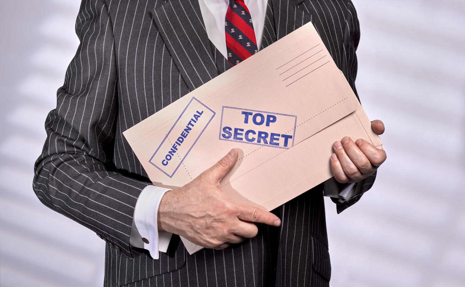 Businessman holding Confidential Top Secret Folder