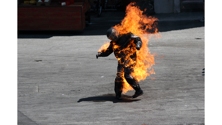 Man in a protective suit wrapped in flames