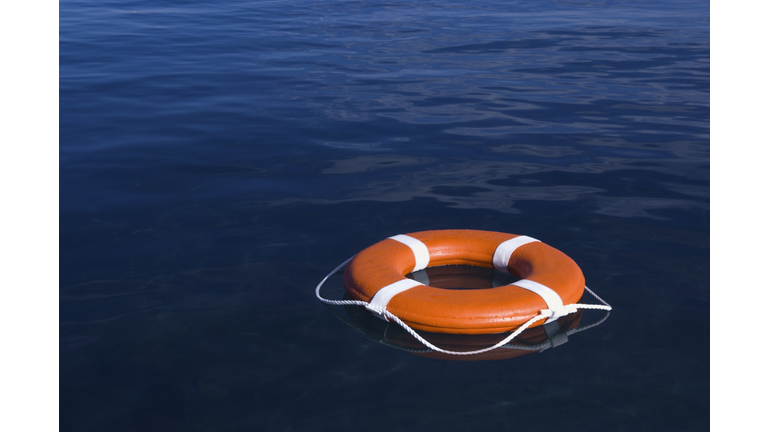 Round life preserver floating in water