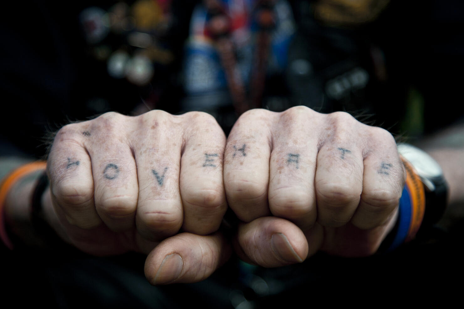 Man with Love & Hate tattooed on his knuckles