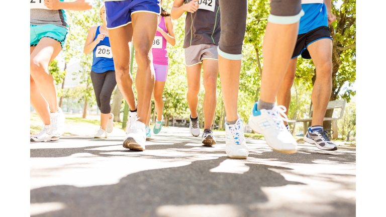 Low Section Of Marathon Runners Competing At Park