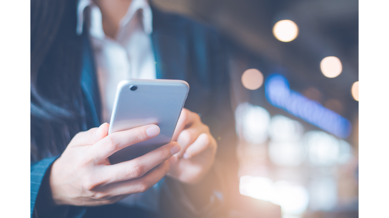 Business women hand are using cell phones in office.