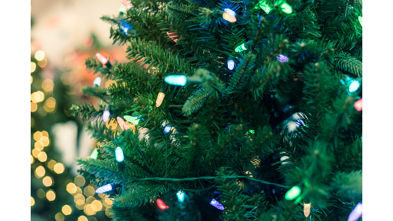 Close-up artificial Christmas tree and pre-lit color-changing lights LED at hardware store in USA