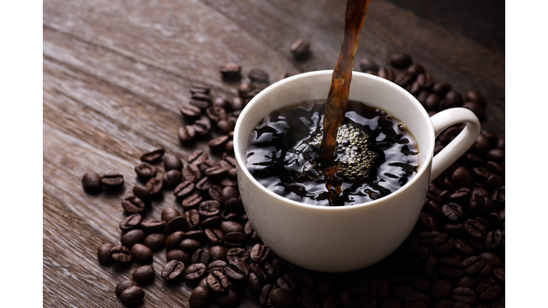 Hot coffee on wooden table