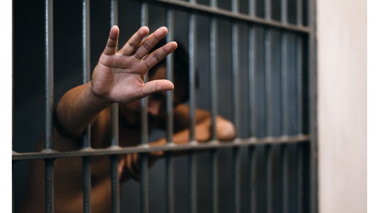 Prisoner Showing Hand While Standing In Prison