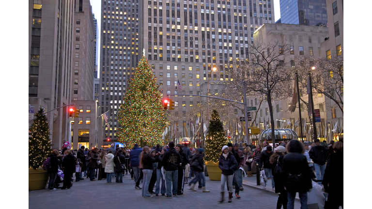 People viewing the Christmas tree at Rockefeller Center at dusk, New York, NY, USA