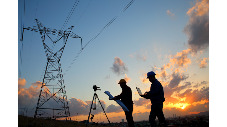 Silhouette of engineers workers at electricity station