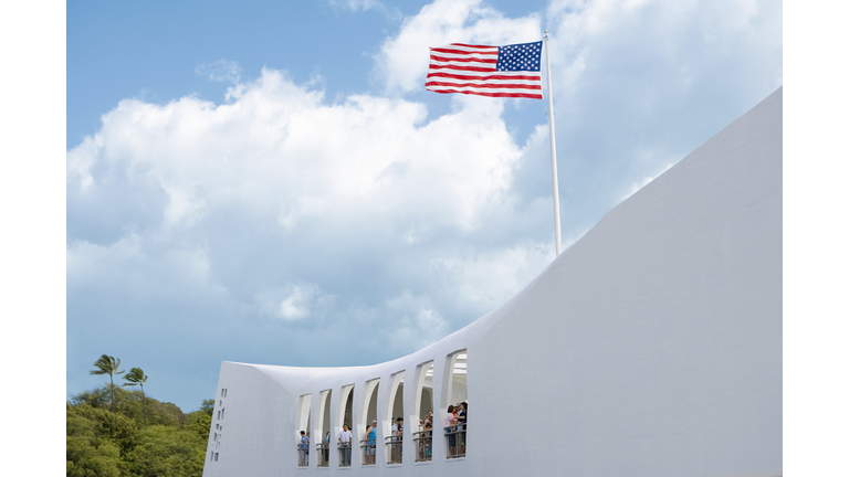 Low angle view of an American flag fluttering on a memorial building, USS Arizona Memorial, Pearl Harbor, Honolulu, Oahu, Hawaii Islands, USA