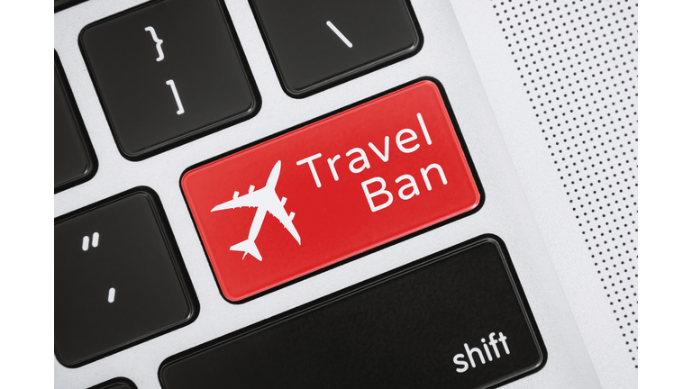 Travel Ban Word and Airplane Icon on Close-up Computer Keyboard Key