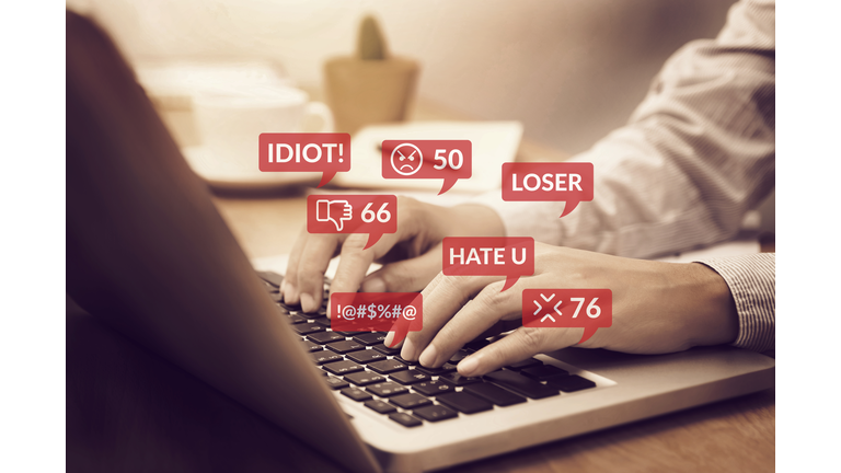 cyber bullying concept. people using notebook computer laptop for social media interactions with notification icons of hate speech and mean comment in social network