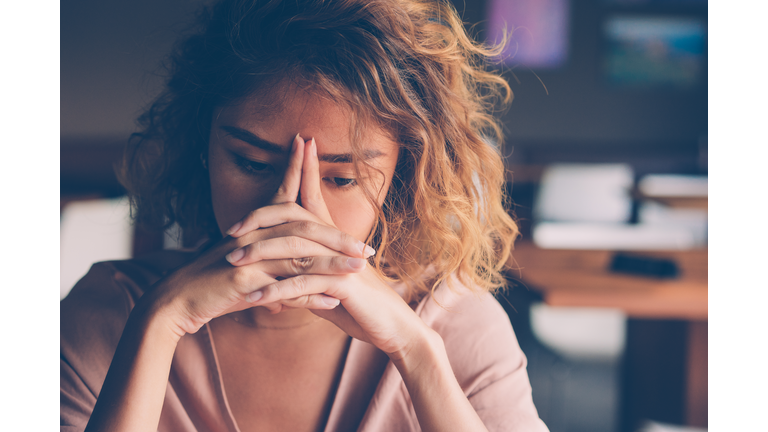 Tired Young Woman Leaning Head on Hands