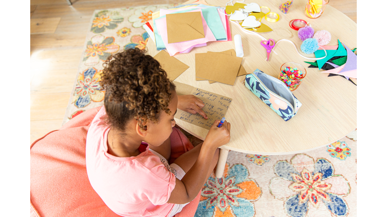 Young girl making a card