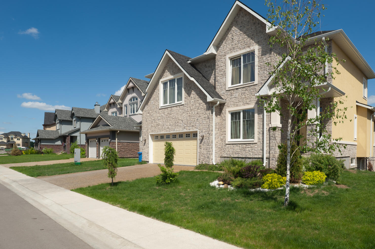 Brand new suburban house in sunny summer afternoon.