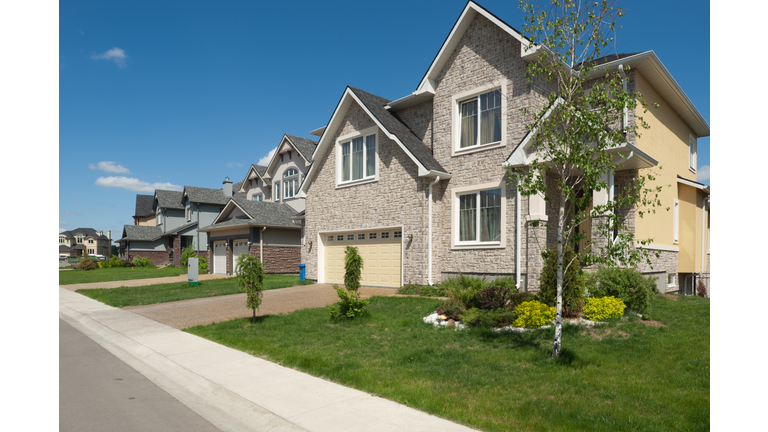Brand new suburban house in sunny summer afternoon.