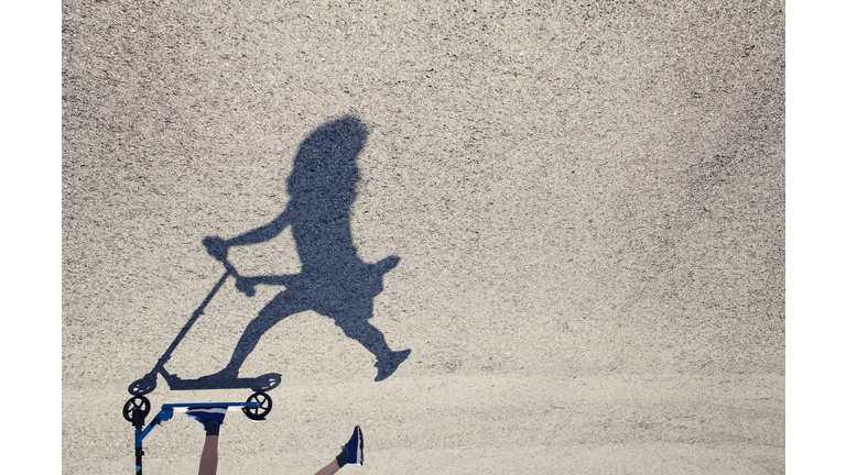 Girl riding her push scooter