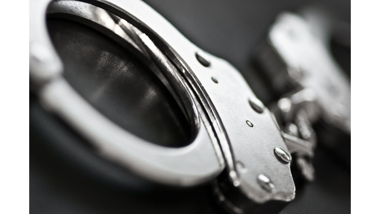 Black and white close-up of silver handcuffs