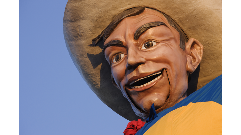 Close up of cowboy mascot under blue sky