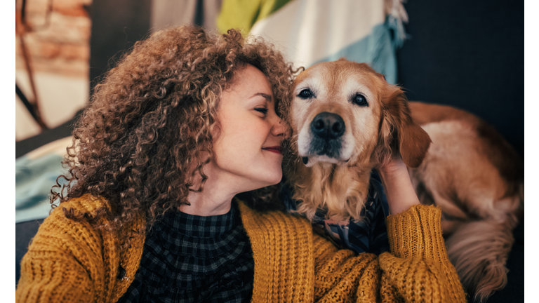 Woman cuddling with her dog