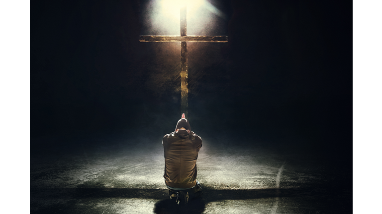 Man Kneeling Before the Cross