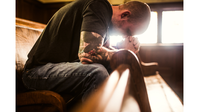 Man Praying in Church