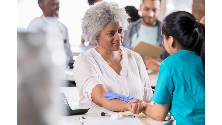 Senior woman receiving flu vaccine