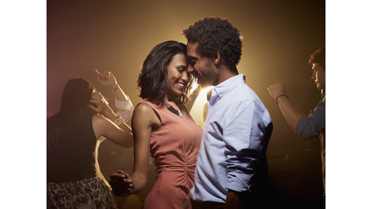 Romantic couple dancing at nightclub