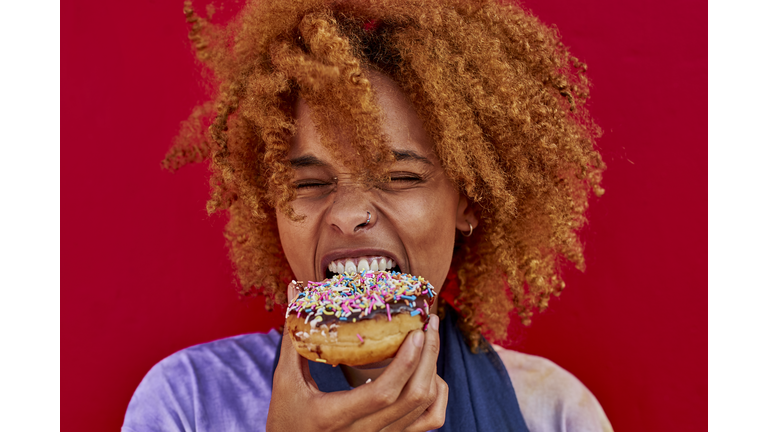 Portrait of woman eating a donut