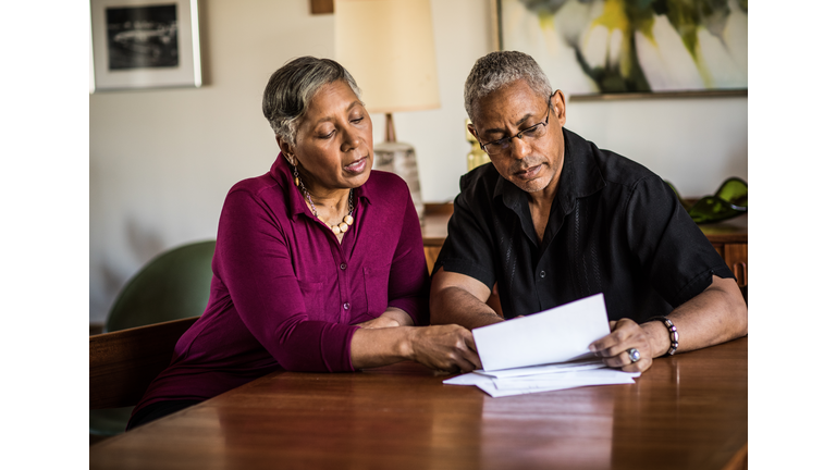 Senior couple (60yrs) paying bills at home