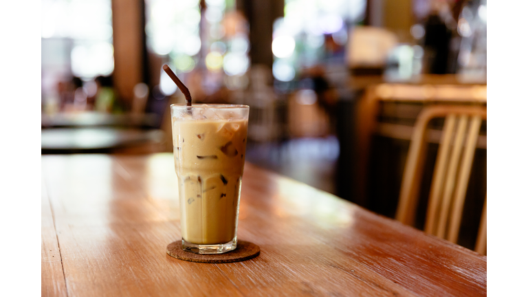 Glass of iced coffee on the table in a coffee shop