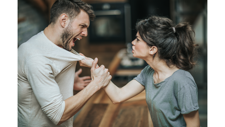 Aggressive couple arguing about their problems at home.