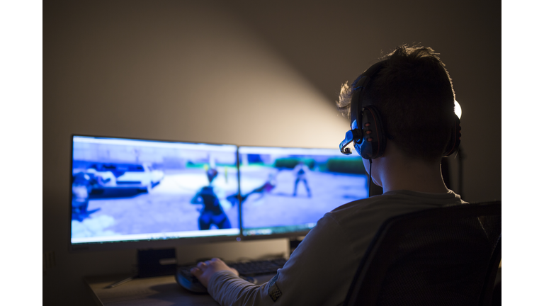 Young boy playing games on a computer at home