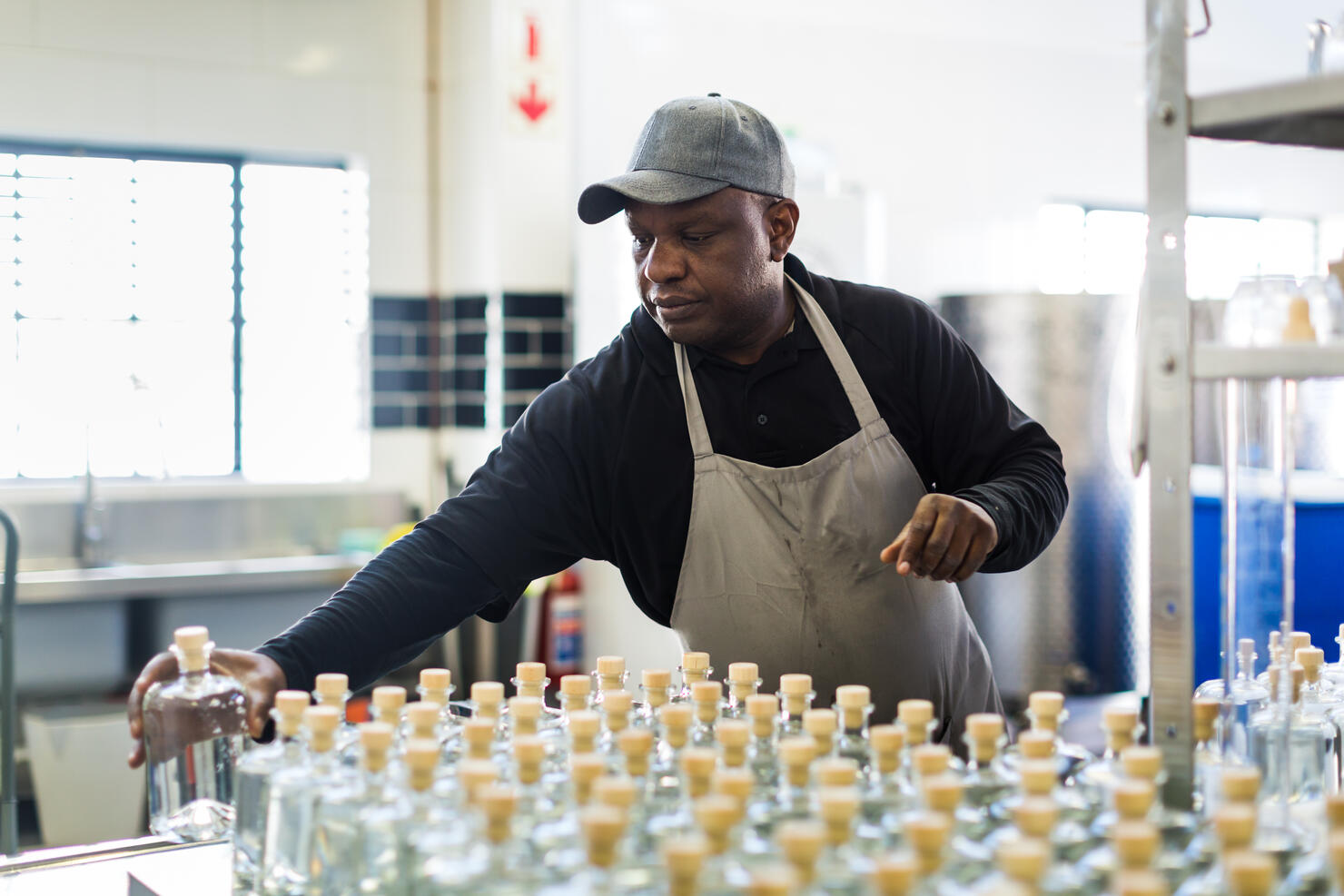 Worker in a small scale gin distillery business