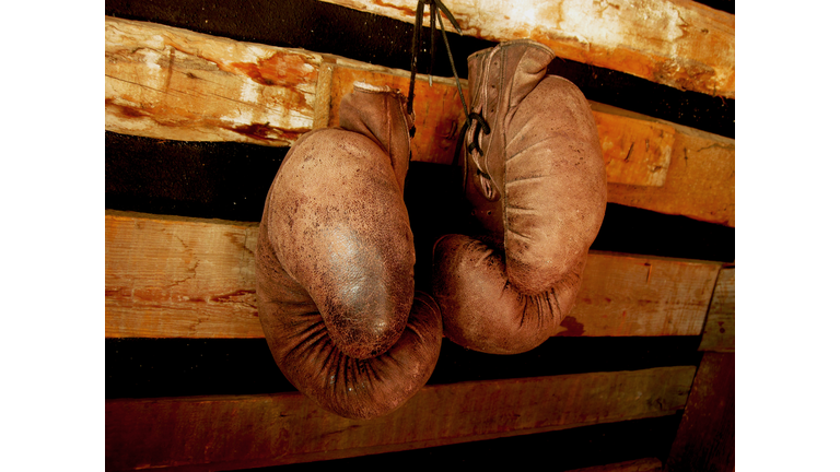 Boxing Gloves On The Wall. Old, Vintage Pair Of Leather Mittens