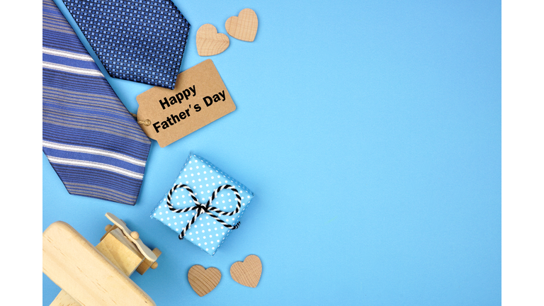 Happy Fathers Day gift tag with side border of gifts, ties and hearts on a blue background