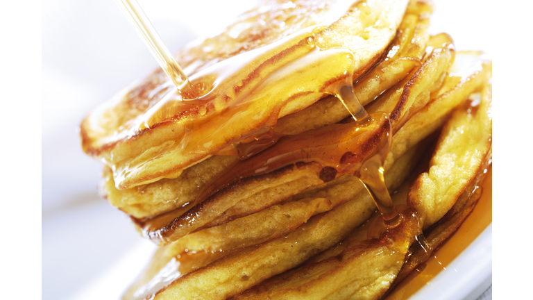 Pancakes poured with maple syrup