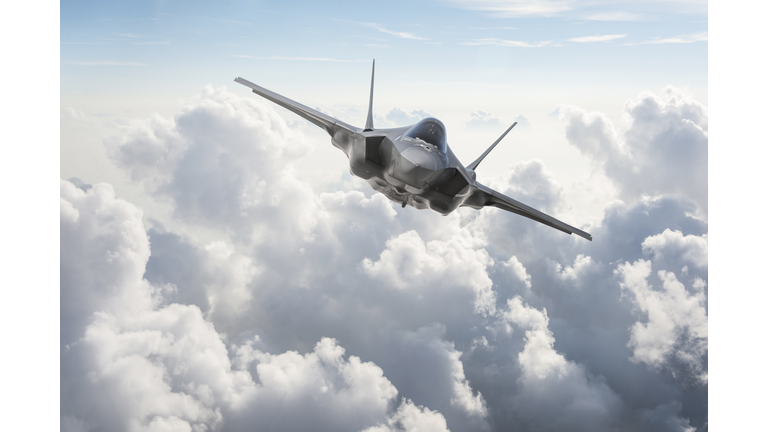 Fighter Jet flying over the clouds