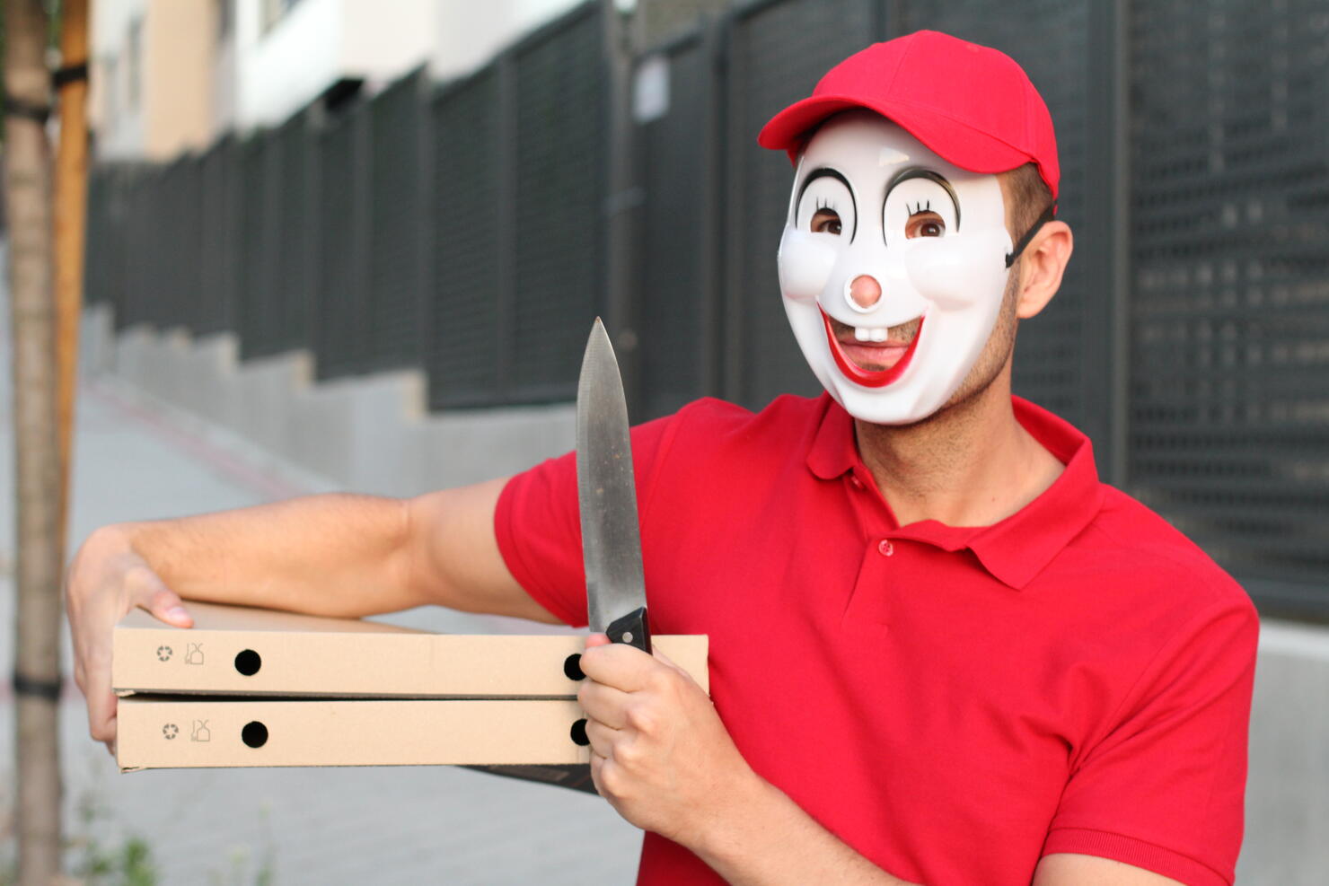 Spooky pizza delivery guy with a knife