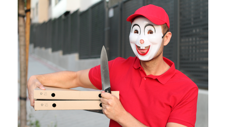 Spooky pizza delivery guy with a knife