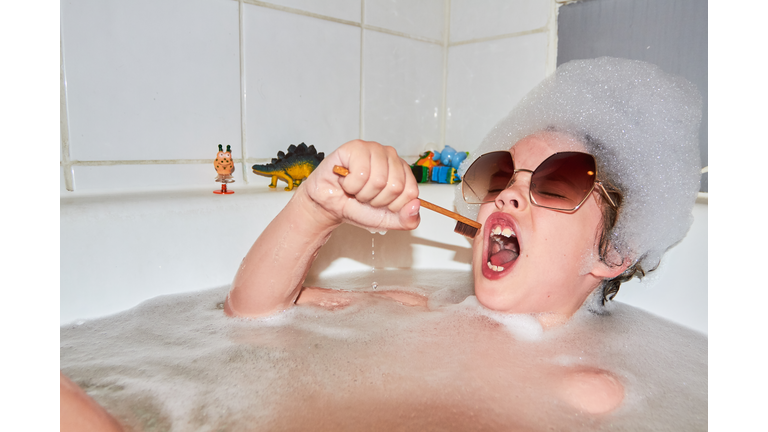Child singing in bubble bath