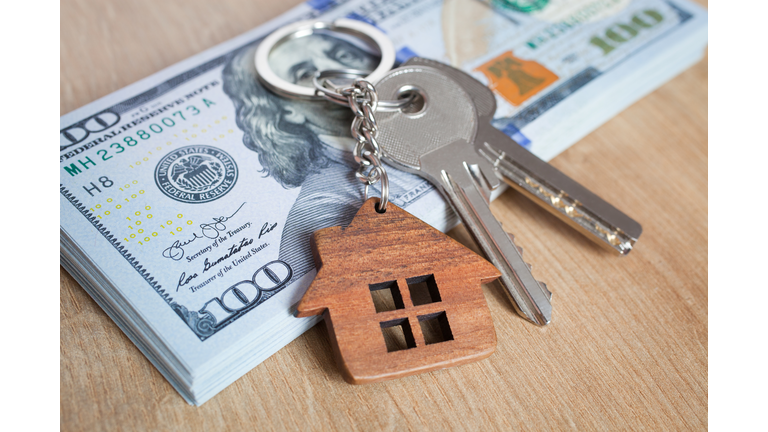 Real estate investing concept. American dollar, cash or housing. Keys close-up