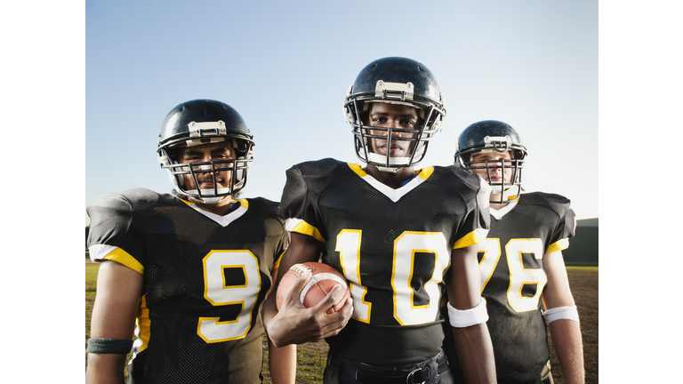 Football players standing on football field