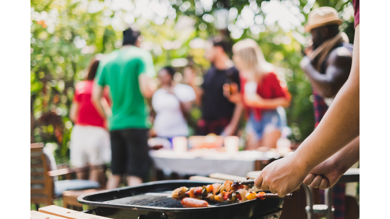 Group of deversity people having barbecue/barbeque party at home, cooking grilled meat/beef for lunch, happy friends party lifestyle concept