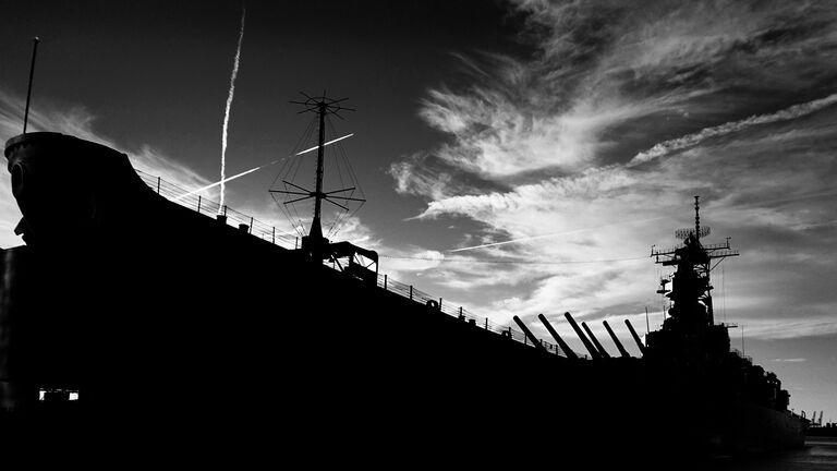 Low Angle View Of Silhouette Us Navy Ship Against Cloudy Sky