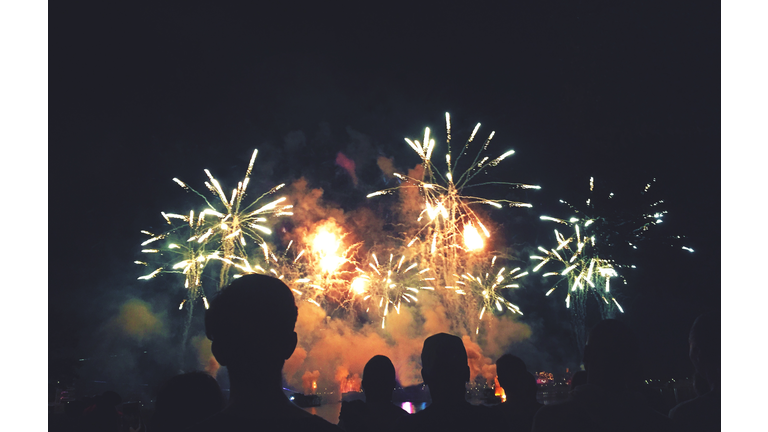 Silhouetted People Watching a Fireworks Display