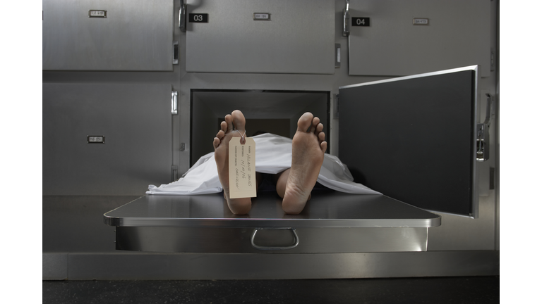 Cadaver on autopsy table, label tied to toe