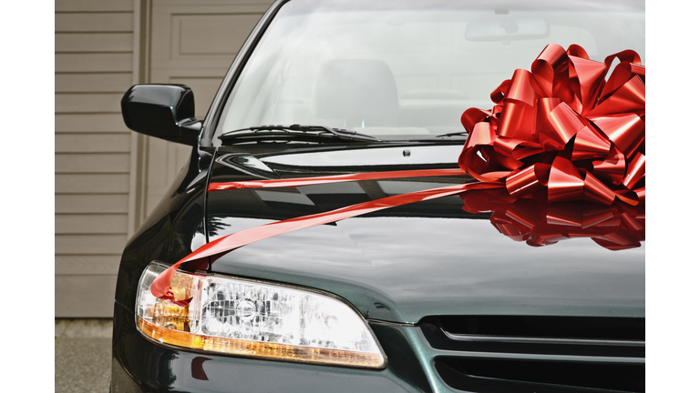 New car with ribbon on hood