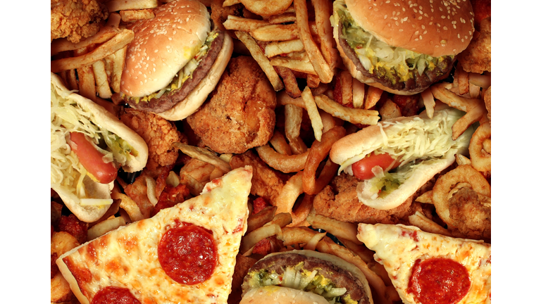 Fast food items like hot dogs, hamburgers, fries and pizza