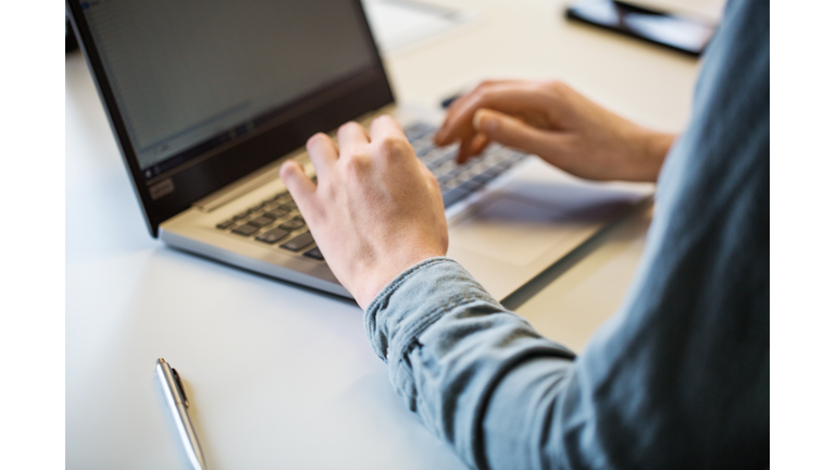 Close up of businesswoman working on laptop