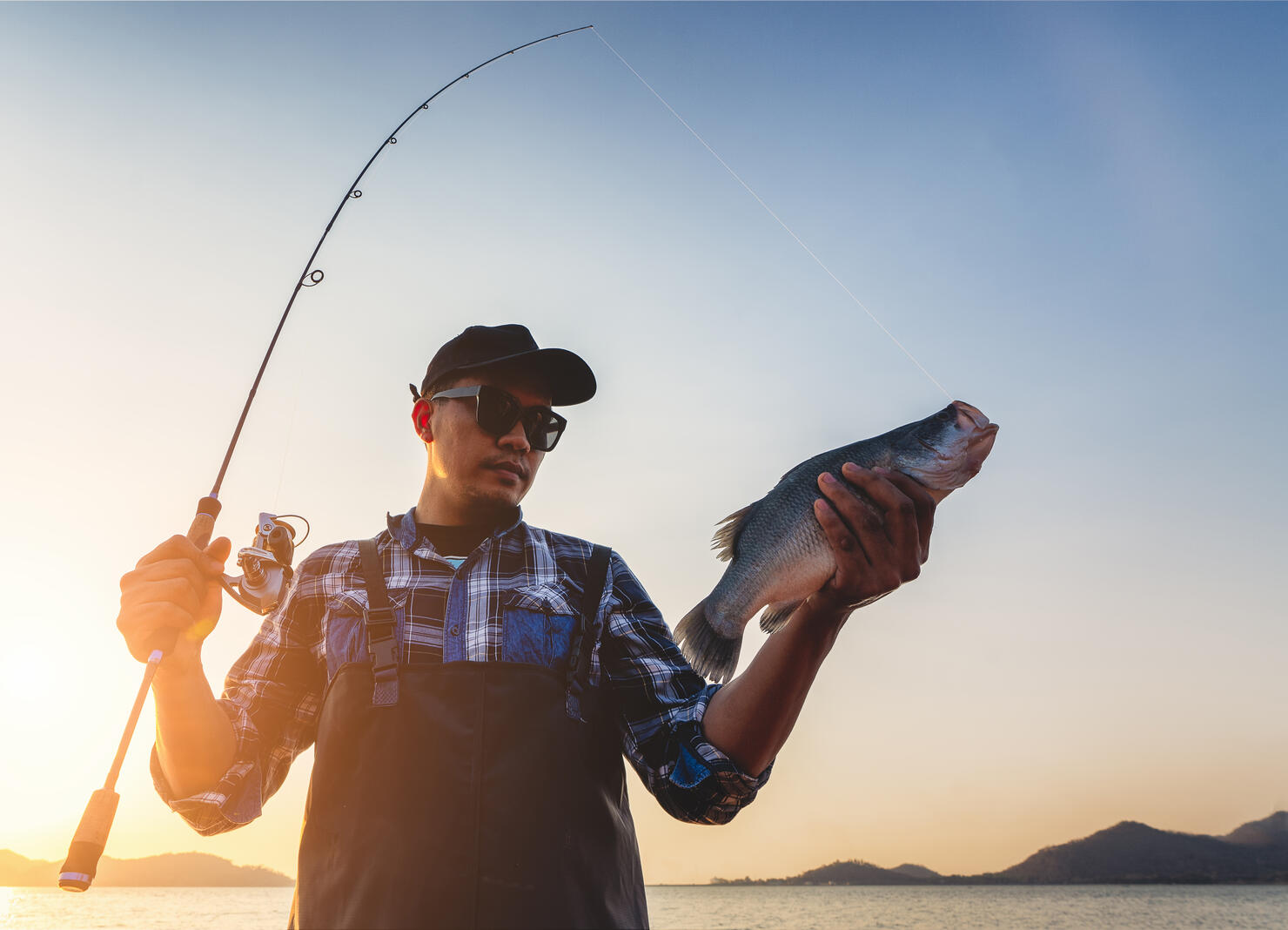 Fisherman holding big fish.