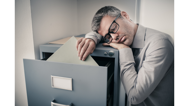 Tired office worker sleeping in the office